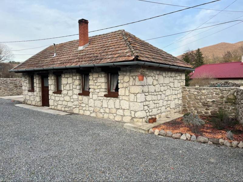 Stone family house with wooden windows and a sloped roof in Boldogkőváralja.