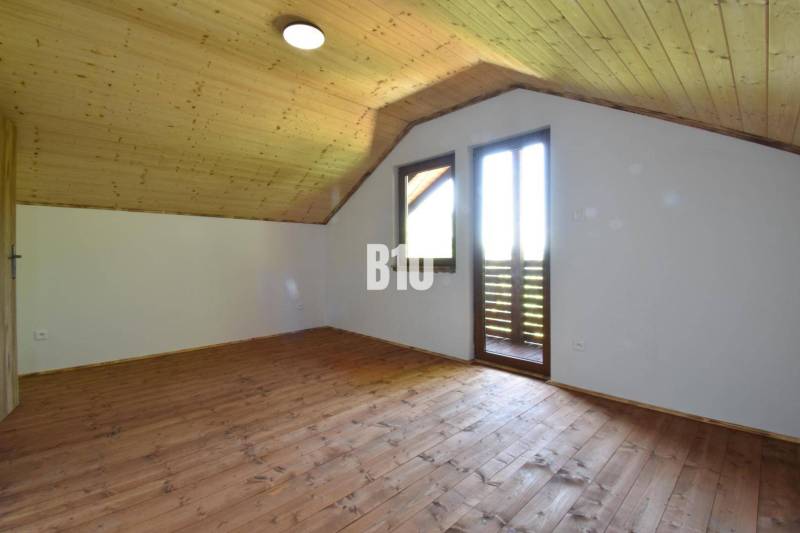 Attic room with wooden paneling and flooring in the Cottage near Bytča.