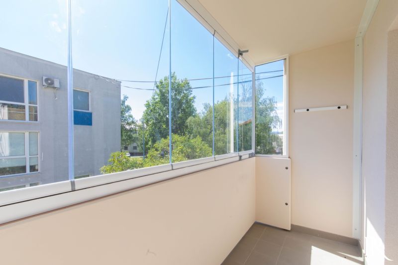 A glazed balcony in a 2-room apartment with a view of greenery in Dubnica nad Váhom.