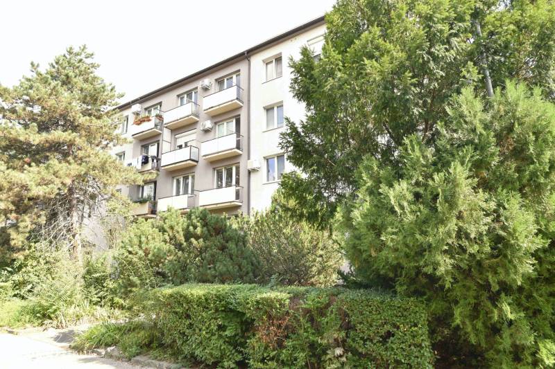 An apartment building surrounded by greenery on Smolnícka Street in Bratislava - Ružinov, with balconies.
