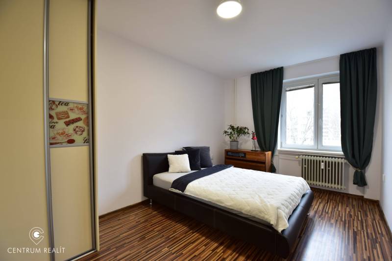 Bedroom in a 2-room apartment with a bed, built-in wardrobe, and window.
