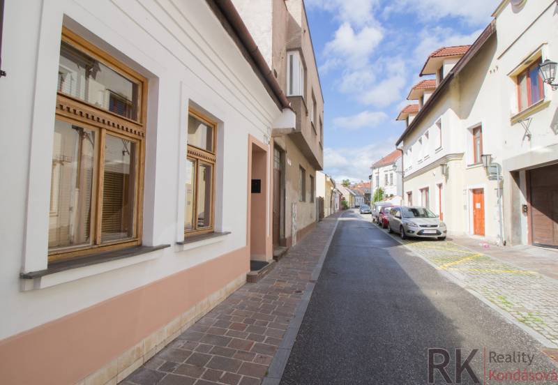 Vrátna Street in Košice, Old Town, with historic facades and parked cars.