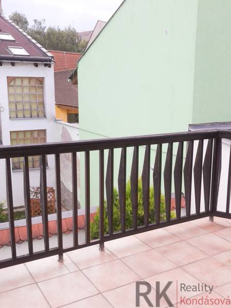 A balcony with a view of buildings, a 2-room apartment on Vrátna Street in Košice.
