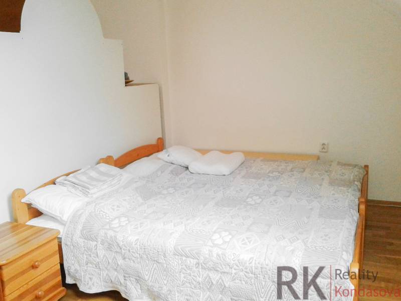A bright bedroom with a double bed in a two-room apartment.