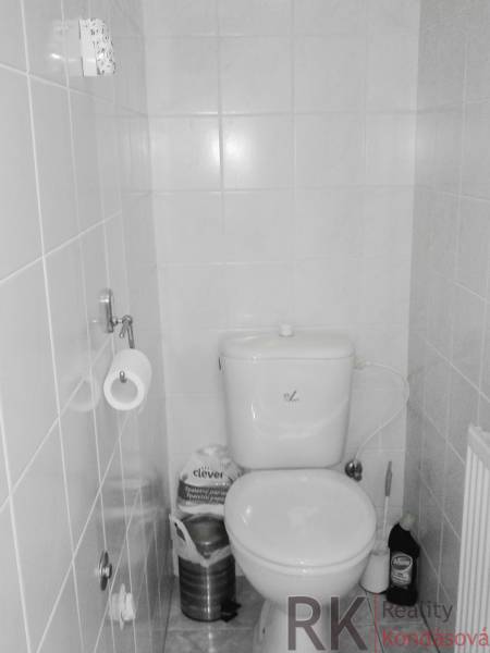 A bathroom in a 2-room apartment with tiled walls and basic equipment.