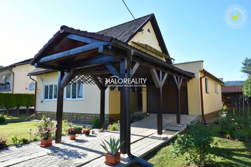 A family house in Župkov with a charming garden, a wooden shelter, and trees in the surroundings.