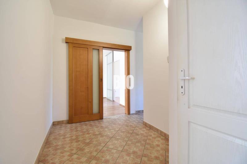 Entrance hallway with sliding doors and tiles in a 4-room apartment.