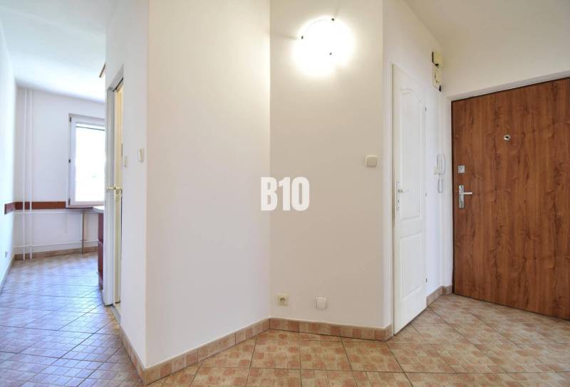 Entrance hall with ceramic tiles in a 4-room apartment displayed.