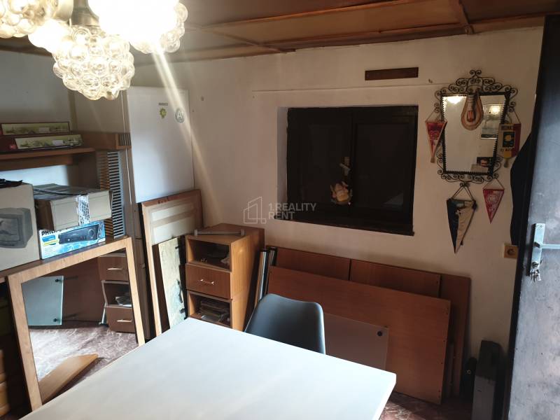 Interior of a cottage with furniture and decorations, a simple storage space.