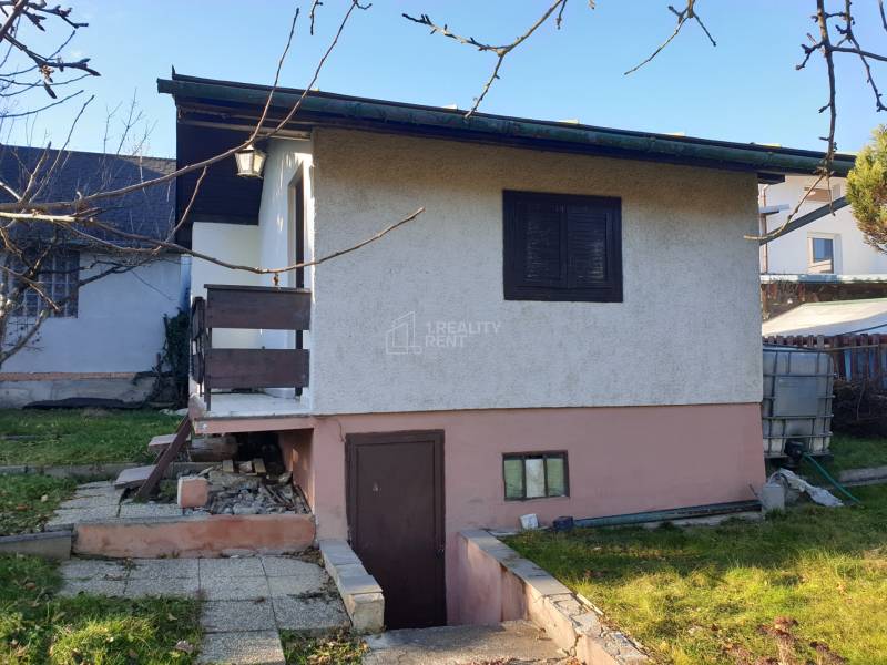 Cottage in Mojšova Lúčka, Žilina, with a garden, stairs, and an outdoor entrance to the cellar.