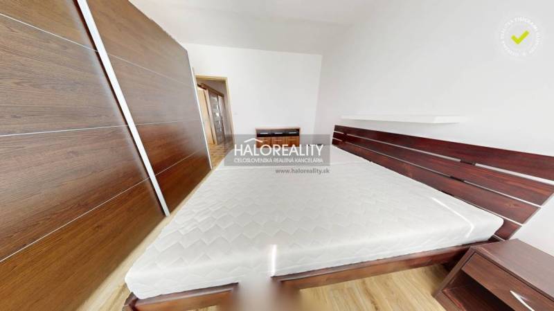 A bedroom in a 3-room apartment with a built-in wardrobe and a bed with a mattress.