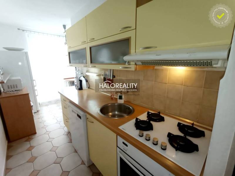 A kitchen in a 3-room apartment with a stove and a dishwasher.
