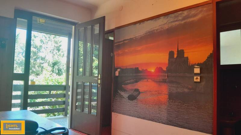 Open balcony, large-format painting with a sunset motif in a family house.