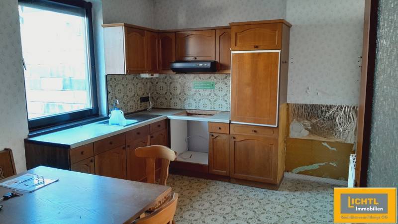Wooden kitchen unit with tiles and table, Apartment construction.