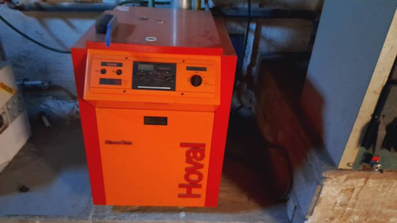 Orange Hoval boiler located in the utility room, Apartment construction.