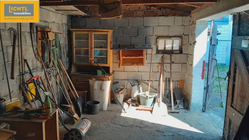 A garage full of tools and equipment under construction of apartments.