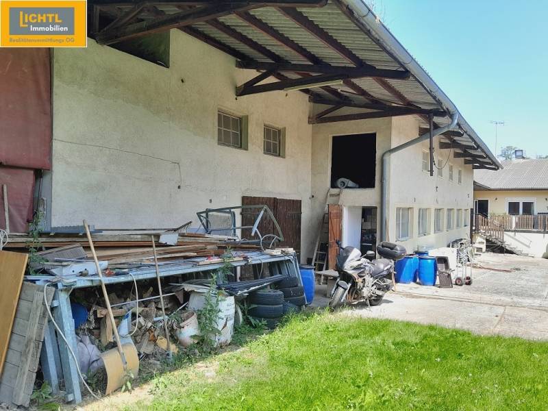 Exterior of Gastro premises in Grossinzersdorf with stored materials and a motorcycle in the yard.