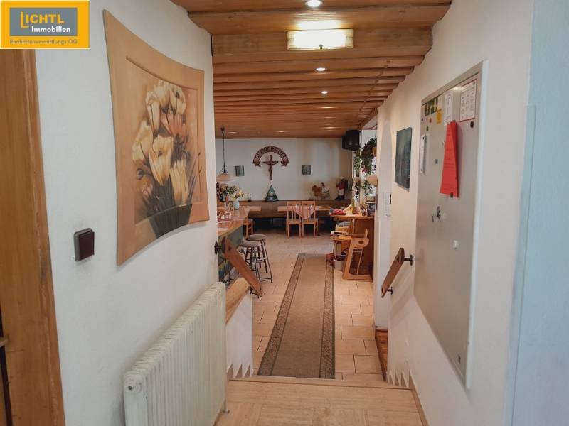 Interior of dining spaces with decorations and wooden elements. The entrance leads to the tables.