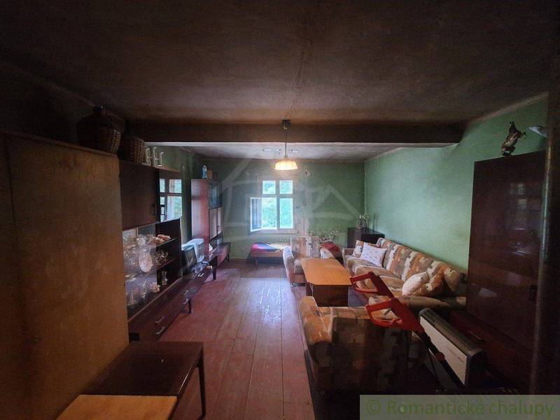 Rustic interior of a cottage with furniture and a sofa in a cozy space.