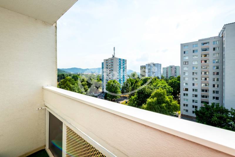 View from the balcony of a 2-room apartment in Humenné overlooking the housing estate and greenery.