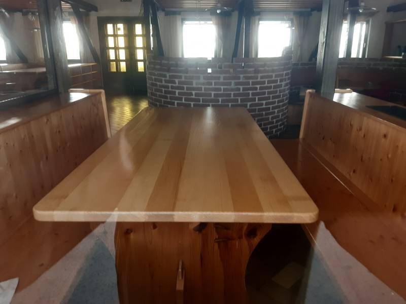 Rustic interior of dining spaces with a wooden table, brick wall on Hornerstraße street.