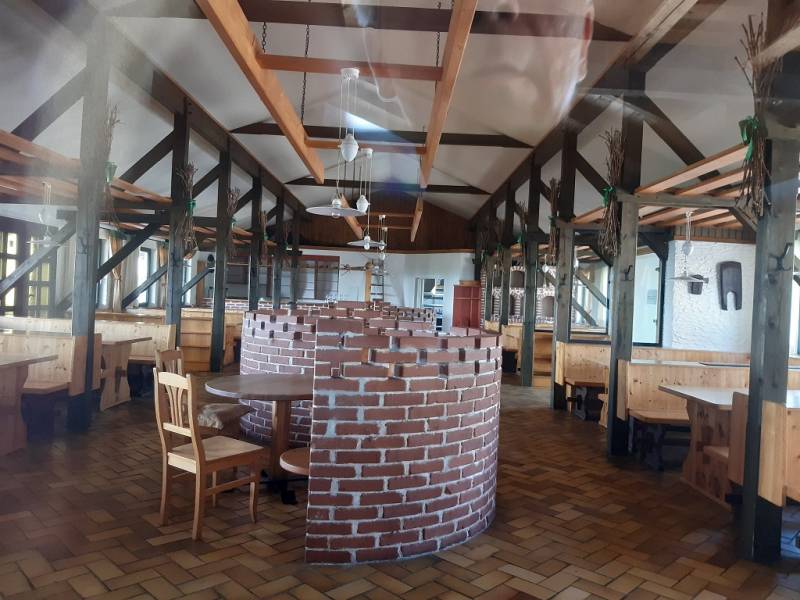 Interior of a restaurant with a brick fireplace on Hornerstraße, ideal for gastronomy spaces.
