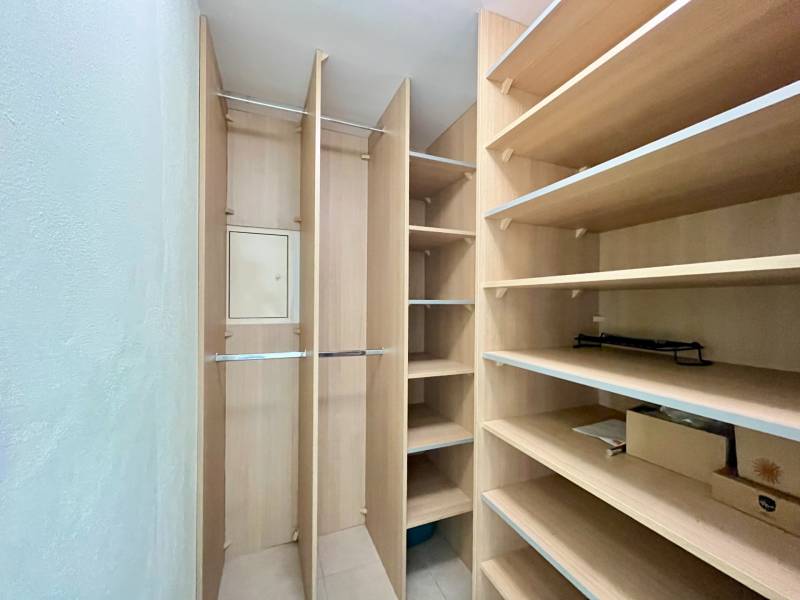 Built-in shelves and racks for storage space in a 2-room apartment.