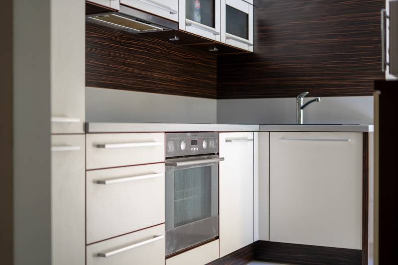 Kitchen in a 3-room apartment with a sink, oven, and cabinets.