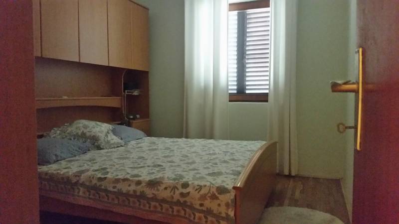 Cozy bedroom with built-in wardrobes and a bed in a family house.