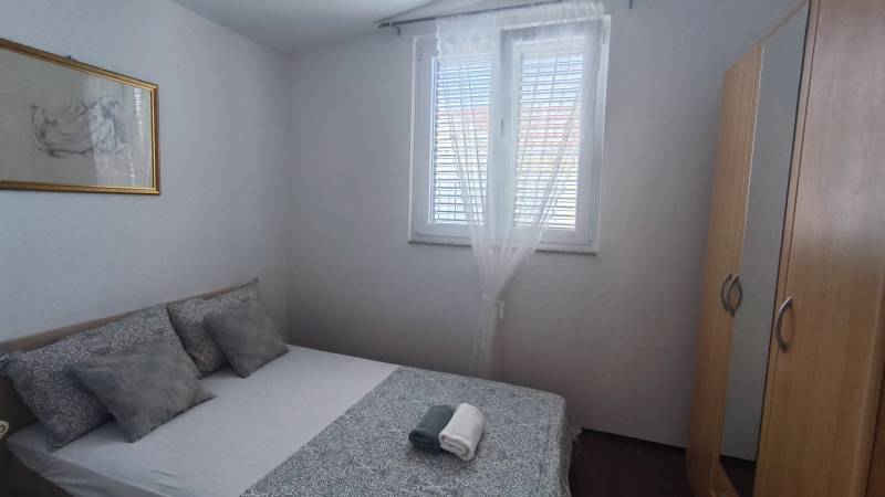 Bedroom with a double bed and a wardrobe, in a family house.