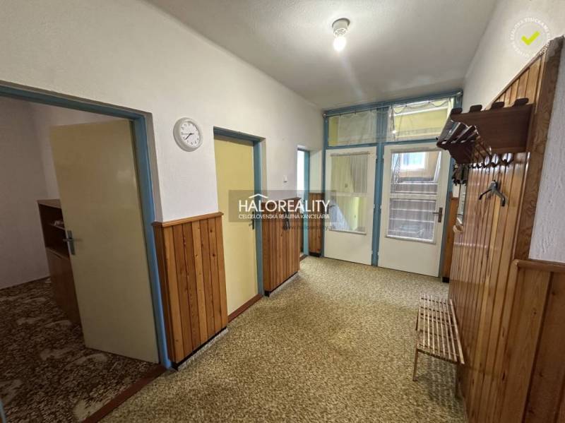 Kitchen in a family house with a stove, dining table, and wall decoration.