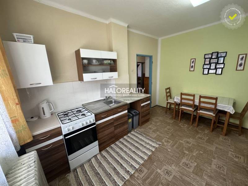 A family house with an interior staircase, wooden door frames, and carpet.