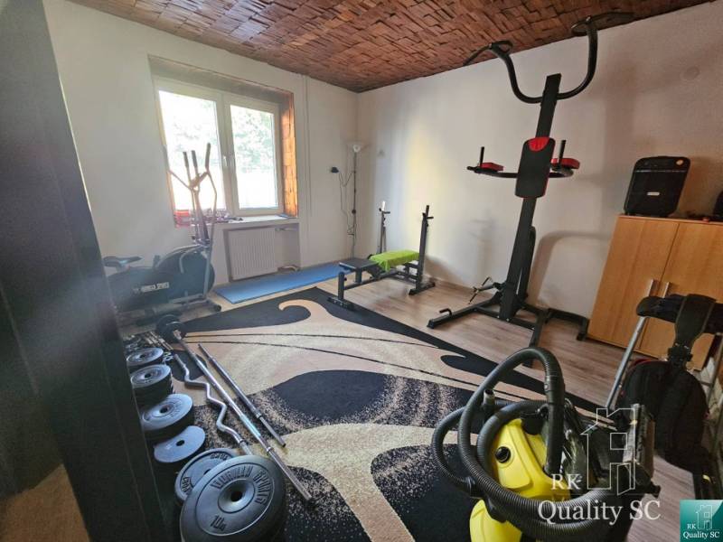 Home gym in a family house with sports equipment and dumbbells.