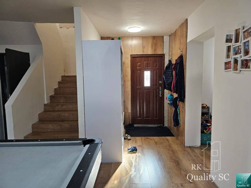 Entrance hall in a family house with wooden stairs and storage space.