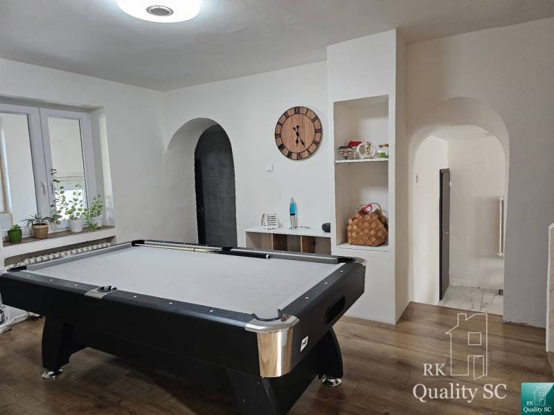 A billiard room with a pool table in a family house, elegant decoration and cozy atmosphere.