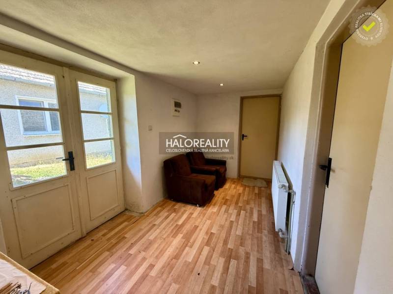 Interior in a family house with wooden flooring and a brown armchair.