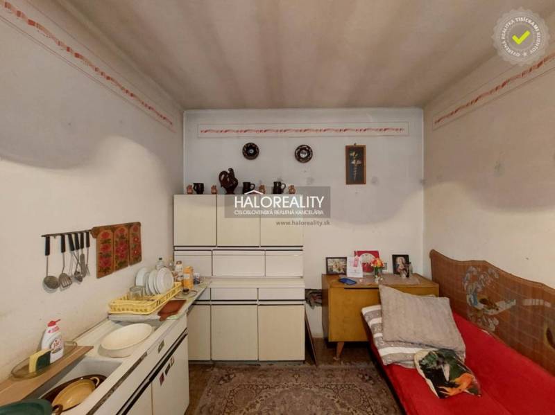 A room in a family house with storage cabinets, a sink, and simple decor.