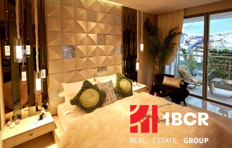 Luxury bedroom in a studio apartment with cozy lighting and a balcony.