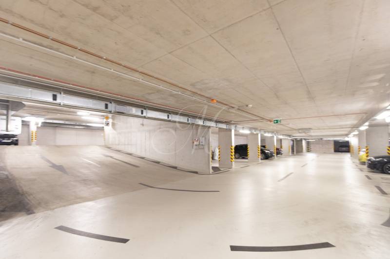 Underground garages with parked cars and a ramp in Bratislava - Ružinov on Košická Street.