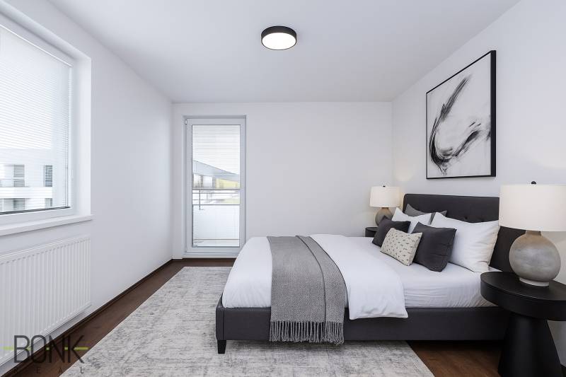 Bright bedroom in a 3-room apartment with a large bed, nightstands, and modern art.