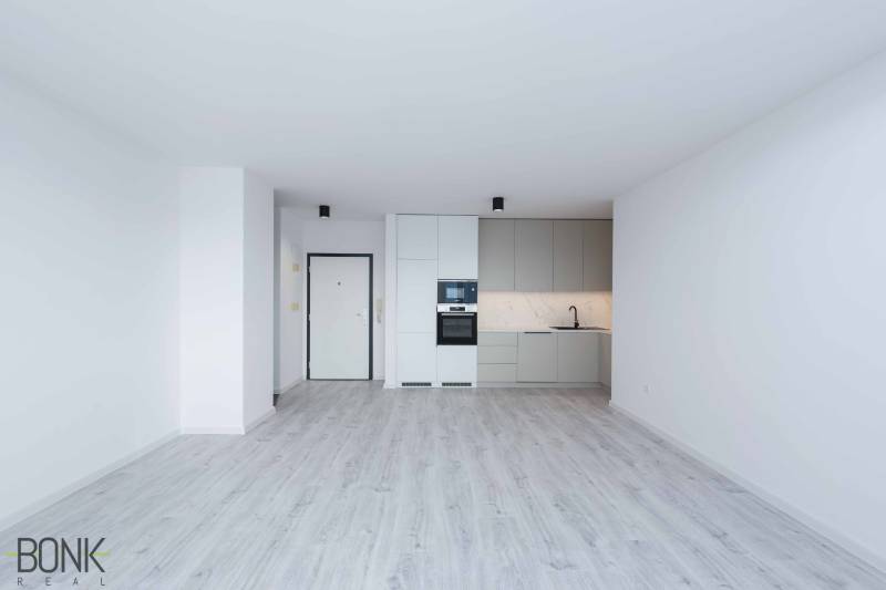 A bright kitchen with a floor in a 3-room apartment, equipped with built-in appliances.
