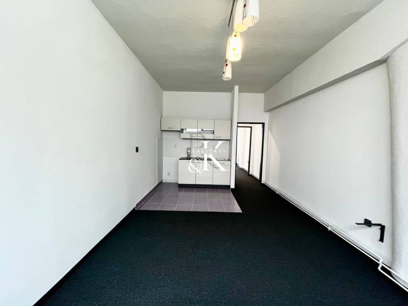 Commercial premises with a kitchen unit and pendant lights.