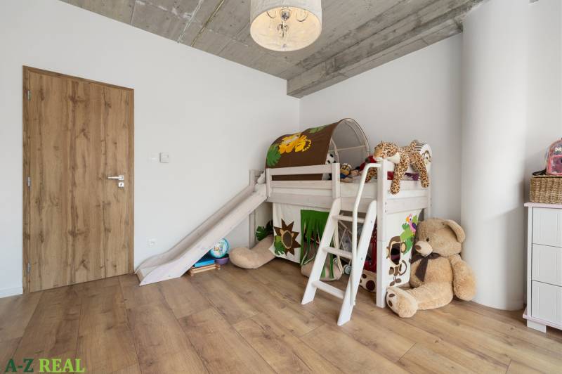 A children's room with a slide and plush toys in a 4-room apartment.