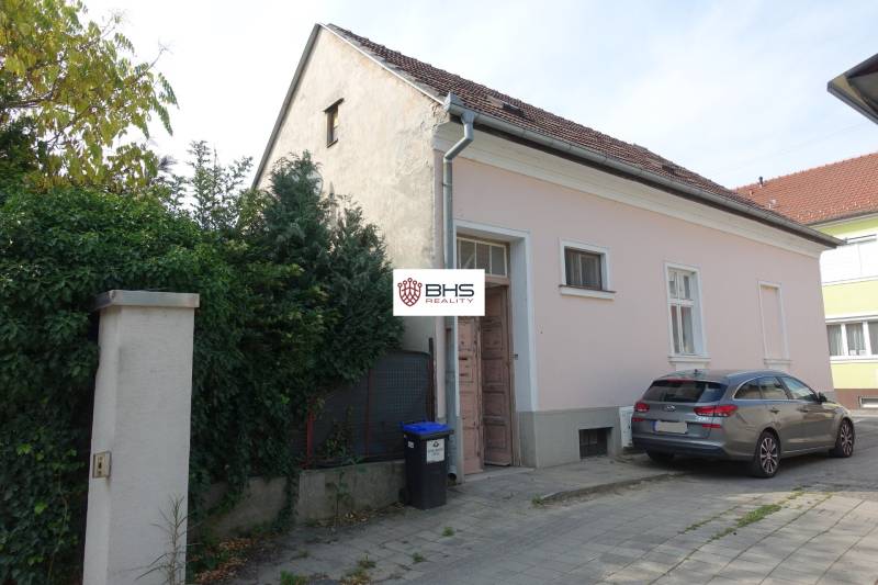 A family house on Hviezdoslavova Street in Piešťany with a car parked on the sidewalk.