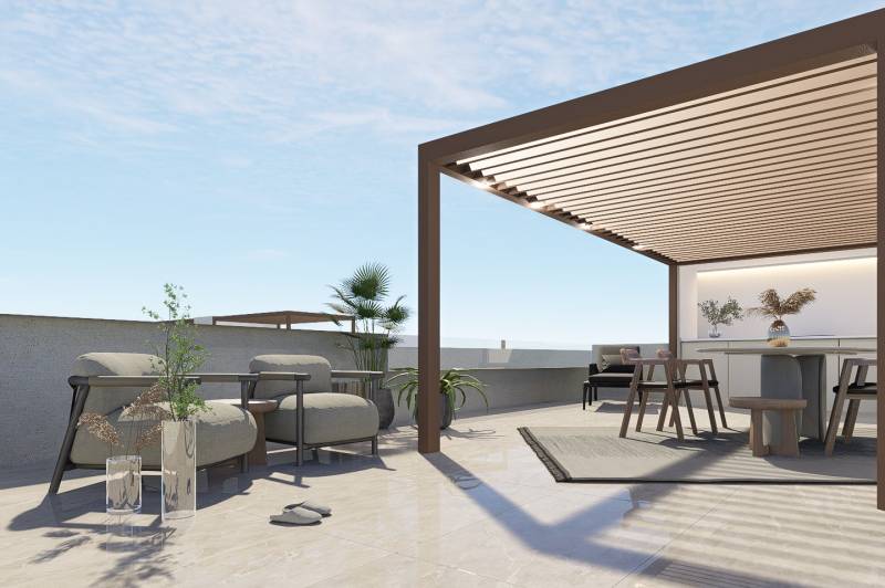 Terrace in a 4-room apartment in Pilar de la Horadada with seating and greenery.