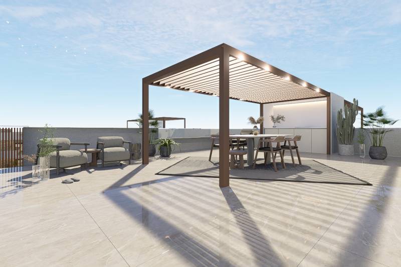 Terrace of a 4-bedroom apartment in Pilar de la Horadada with a pergola and garden furniture.