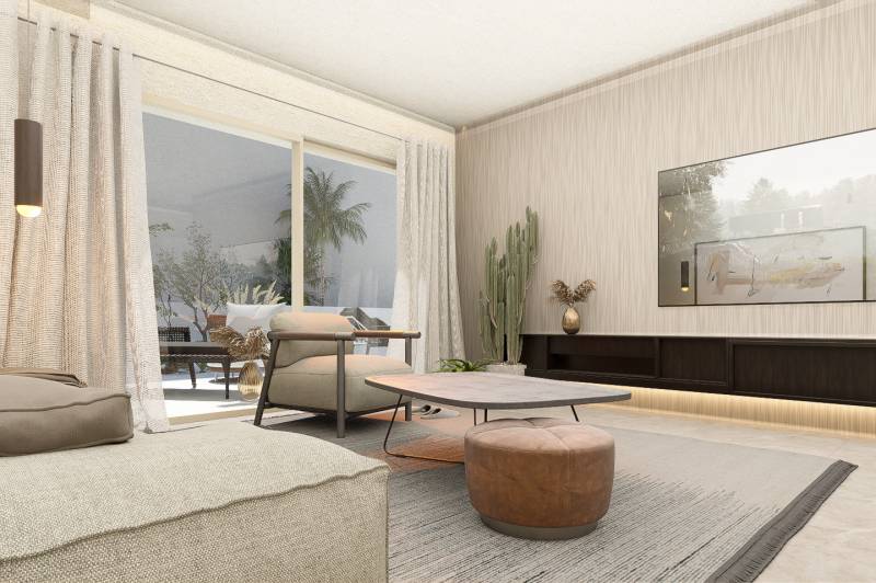 Living room with an armchair, table, cactus, and large window in a 4-room apartment.