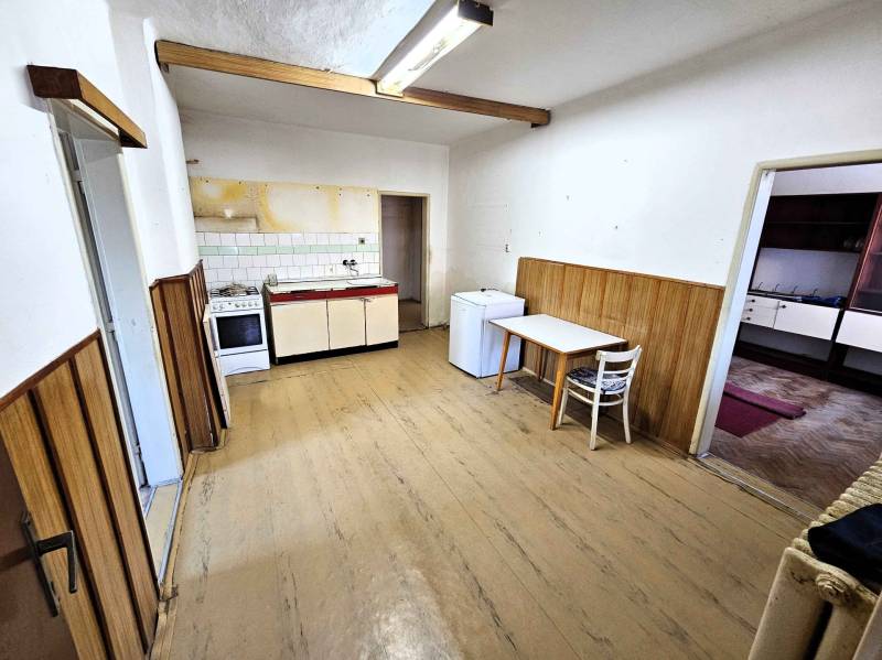 Simple kitchen with wooden paneling in a family house.