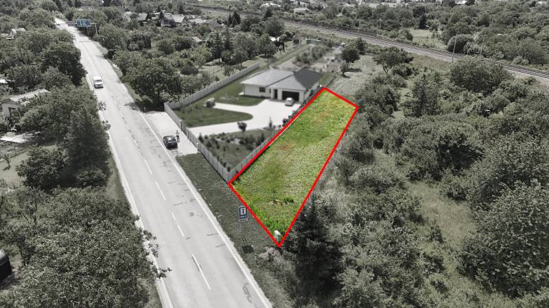 A plot for residential use with two roads and vegetation in Nové Mesto nad Váhom.