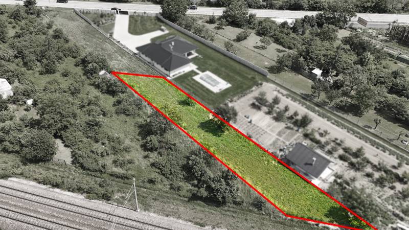 Aerial view of plots - housing in Nové Mesto nad Váhom, enclosed by a red line.